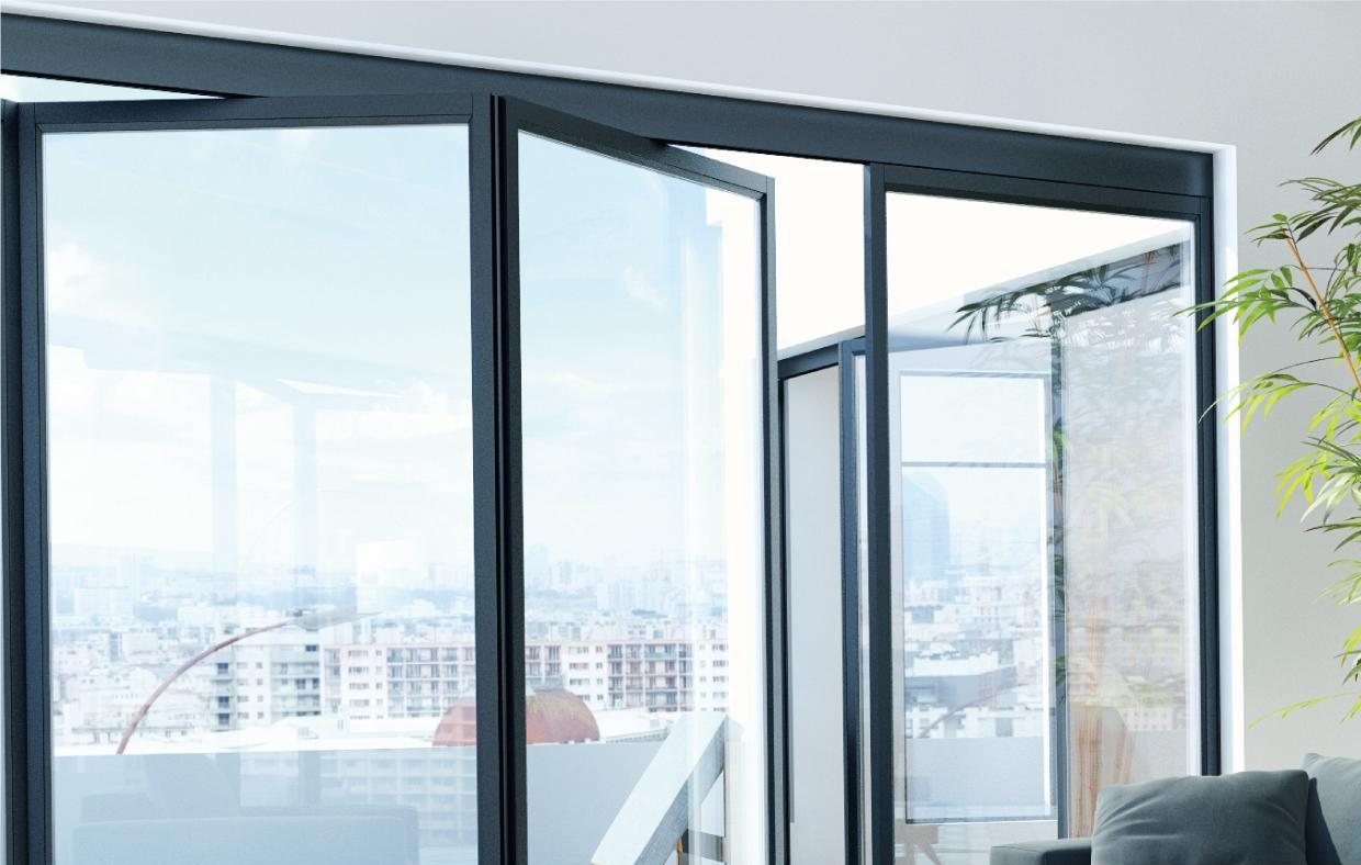 Black aluminum folding door opening a living room to a terrace